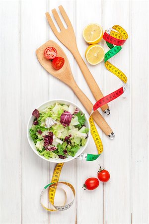 simsearch:400-06485512,k - Fresh healthy salad, utensils and tape measure over white wooden table. View from above Stock Photo - Budget Royalty-Free & Subscription, Code: 400-07922889