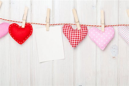 Photo frame and valentines day toy hearts over white wooden background Foto de stock - Super Valor sin royalties y Suscripción, Código: 400-07922903
