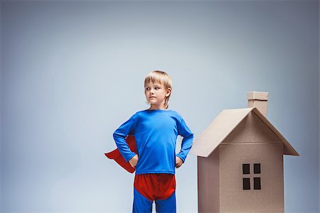 rescuer - Boy in a superman costume with cardboard house Stock Photo - Budget Royalty-Free & Subscription, Code: 400-07923609