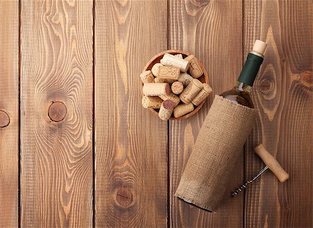 simsearch:400-07933837,k - White wine bottle, bowl with corks and corkscrew. View from above over rustic wooden table background Stockbilder - Microstock & Abonnement, Bildnummer: 400-07934004