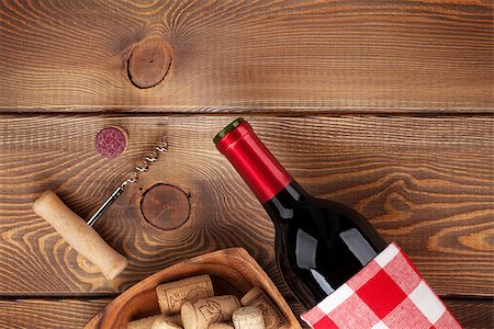 simsearch:400-07933837,k - Red wine bottle, bowl with corks and corkscrew. View from above over rustic wooden table background Stockbilder - Microstock & Abonnement, Bildnummer: 400-07934009