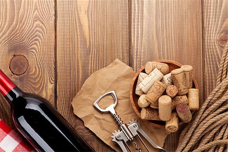 simsearch:400-07933837,k - Red wine bottle, bowl with corks and corkscrew. View from above over rustic wooden table background Stockbilder - Microstock & Abonnement, Bildnummer: 400-07934003