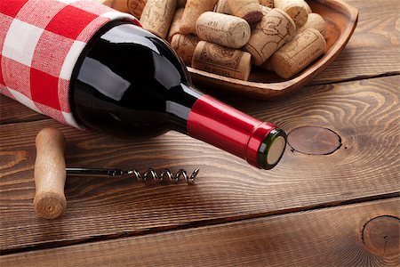 simsearch:400-07933837,k - Red wine bottle, bowl with corks and corkscrew. Closeup over rustic wooden table background Stockbilder - Microstock & Abonnement, Bildnummer: 400-07934010