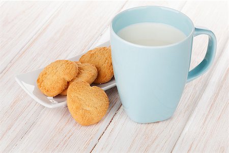 Cup of milk and heart shaped cookies on white wooden table Stock Photo - Budget Royalty-Free & Subscription, Code: 400-07934034