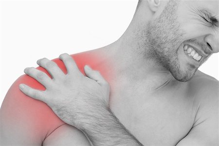 simsearch:6109-06684724,k - Closeup of young shirtless man with shoulder pain over white background Stock Photo - Budget Royalty-Free & Subscription, Code: 400-07934212