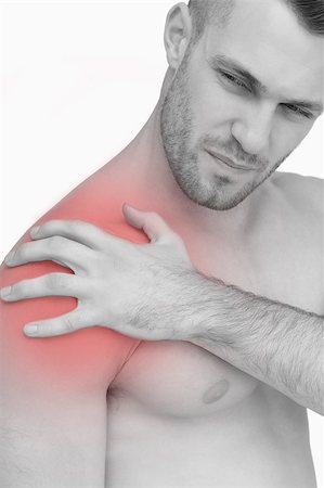 simsearch:6109-06684724,k - Closeup of shirtless man with shoulder pain over white background Stock Photo - Budget Royalty-Free & Subscription, Code: 400-07934240