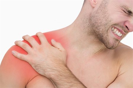 simsearch:6109-06684724,k - Closeup of young shirtless man with shoulder pain over white background Stock Photo - Budget Royalty-Free & Subscription, Code: 400-07934308