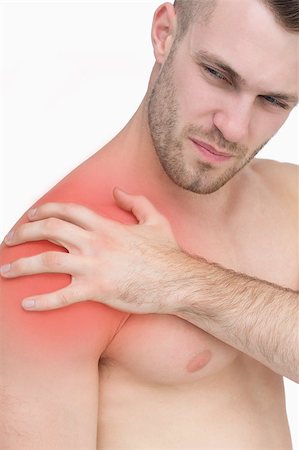 simsearch:6109-06684724,k - Closeup of shirtless man with shoulder pain over white background Stock Photo - Budget Royalty-Free & Subscription, Code: 400-07934326