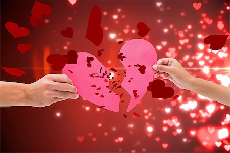 simsearch:400-07957212,k - Hands holding two halves of broken heart against valentines heart design Stock Photo - Budget Royalty-Free & Subscription, Code: 400-07934464