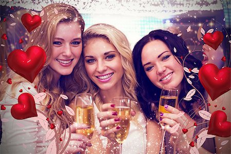 pretty woman laughter party - Pretty friends drinking champagne together against valentines heart design Stock Photo - Budget Royalty-Free & Subscription, Code: 400-07934559