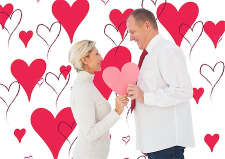 simsearch:400-07726694,k - Older affectionate couple holding pink heart shape against valentines day pattern Foto de stock - Royalty-Free Super Valor e Assinatura, Número: 400-07934569