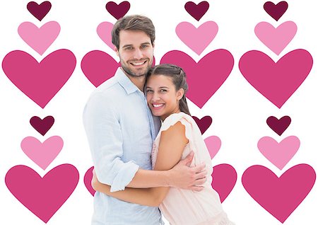 simsearch:400-07957805,k - Attractive young couple hugging and smiling at camera against valentines day pattern Photographie de stock - Aubaine LD & Abonnement, Code: 400-07934571