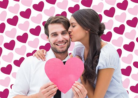 simsearch:400-07957805,k - Pretty brunette giving boyfriend a kiss and her heart against valentines day pattern Photographie de stock - Aubaine LD & Abonnement, Code: 400-07934572