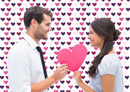 simsearch:400-07957006,k - Pretty brunette giving boyfriend her heart against valentines day pattern Stock Photo - Budget Royalty-Free & Subscription, Code: 400-07934573