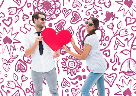 simsearch:400-07957006,k - Hipster couple smiling at camera holding a heart against valentines pattern Stock Photo - Budget Royalty-Free & Subscription, Code: 400-07934607