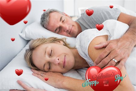 simsearch:400-06891122,k - Couple sleeping and spooning in bed against happy valentines day Photographie de stock - Aubaine LD & Abonnement, Code: 400-07934858