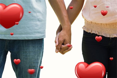 simsearch:400-07957006,k - Young couple holding hands in the park against hearts Stock Photo - Budget Royalty-Free & Subscription, Code: 400-07935030
