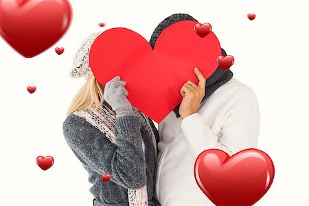 simsearch:400-07957430,k - Couple in winter fashion posing with heart shape against hearts Photographie de stock - Aubaine LD & Abonnement, Code: 400-07935102