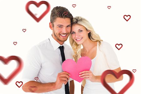 simsearch:400-07957805,k - Attractive young couple holding pink heart against hearts Photographie de stock - Aubaine LD & Abonnement, Code: 400-07935196