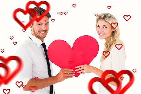 simsearch:400-07726694,k - Attractive young couple holding red heart against hearts Foto de stock - Royalty-Free Super Valor e Assinatura, Número: 400-07935197