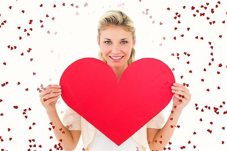 simsearch:400-07726694,k - Attractive young blonde showing red heart against red love hearts Foto de stock - Royalty-Free Super Valor e Assinatura, Número: 400-07935191