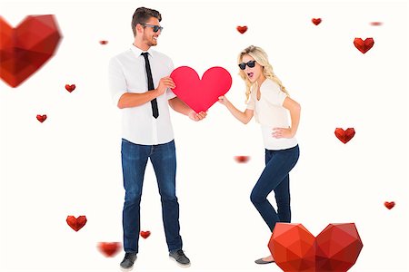 simsearch:400-07935196,k - Cool young couple holding red heart against hearts Foto de stock - Royalty-Free Super Valor e Assinatura, Número: 400-07935204