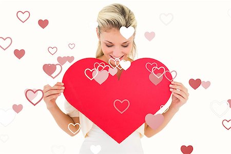simsearch:400-07726694,k - Attractive young blonde showing red heart against valentines heart design Foto de stock - Royalty-Free Super Valor e Assinatura, Número: 400-07935206