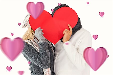 simsearch:400-07957430,k - Couple in winter fashion posing with heart shape against hearts Photographie de stock - Aubaine LD & Abonnement, Code: 400-07935241