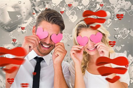 simsearch:400-07935196,k - Attractive young couple holding pink hearts over eyes against grey valentines heart pattern Foto de stock - Royalty-Free Super Valor e Assinatura, Número: 400-07935258