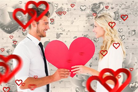 simsearch:400-07686534,k - Attractive young couple holding red heart against grey valentines heart pattern Foto de stock - Royalty-Free Super Valor e Assinatura, Número: 400-07935260