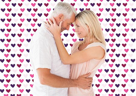 simsearch:400-07957006,k - Affectionate couple standing and hugging against valentines day pattern Stock Photo - Budget Royalty-Free & Subscription, Code: 400-07935296