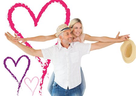 simsearch:400-07957805,k - Happy man giving his partner a piggy back against valentines love hearts Photographie de stock - Aubaine LD & Abonnement, Code: 400-07935299