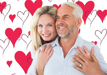 simsearch:400-07957006,k - Smiling couple embracing with woman looking at camera against valentines day pattern Stock Photo - Budget Royalty-Free & Subscription, Code: 400-07935292