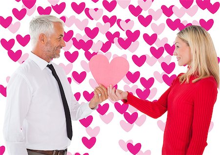 simsearch:400-07935196,k - Handsome man getting a heart card form wife against valentines day pattern Foto de stock - Royalty-Free Super Valor e Assinatura, Número: 400-07935303