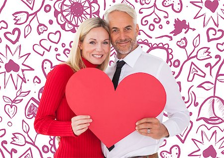 simsearch:400-07935196,k - Handsome man getting a heart card form wife against valentines pattern Foto de stock - Royalty-Free Super Valor e Assinatura, Número: 400-07935320