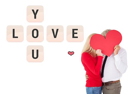 simsearch:400-07935196,k - Handsome man getting a heart card form wife against love you tiles Foto de stock - Royalty-Free Super Valor e Assinatura, Número: 400-07935321