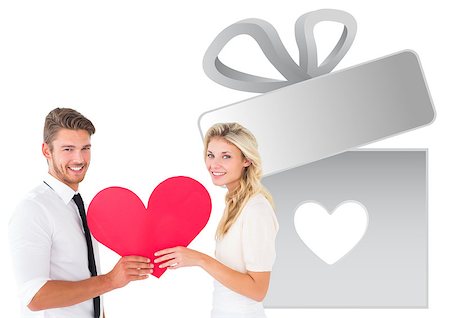 Attractive young couple holding red heart against gift with heart Stock Photo - Budget Royalty-Free & Subscription, Code: 400-07935350