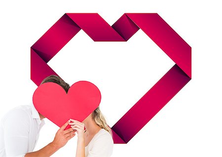 simsearch:400-07957805,k - Attractive young couple kissing behind large heart against heart Photographie de stock - Aubaine LD & Abonnement, Code: 400-07935352