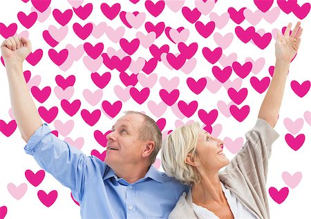 simsearch:400-07957006,k - Happy mature couple with hands up against valentines day pattern Stock Photo - Budget Royalty-Free & Subscription, Code: 400-07935387