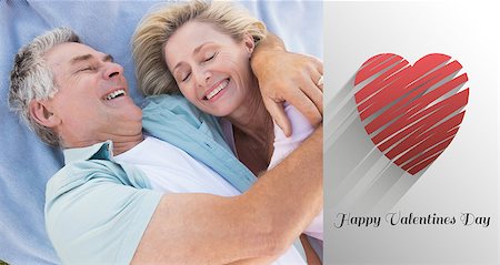 Happy senior couple cuddling on blanket against cute valentines message Stock Photo - Budget Royalty-Free & Subscription, Code: 400-07935486