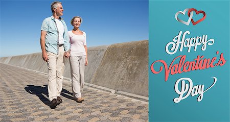Happy senior couple walking on the pier against cute valentines message Stock Photo - Budget Royalty-Free & Subscription, Code: 400-07935491
