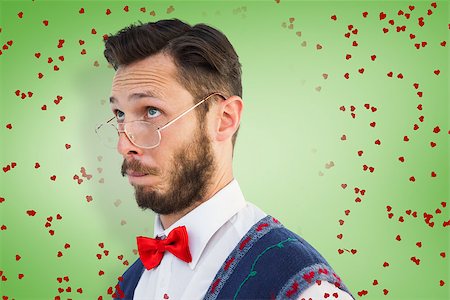 simsearch:400-08380794,k - Geeky hipster wearing christmas vest against green vignette Stockbilder - Microstock & Abonnement, Bildnummer: 400-07935816