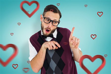 simsearch:400-08380794,k - Geeky hipster in sweater vest pointing  against blue vignette background Stockbilder - Microstock & Abonnement, Bildnummer: 400-07935820