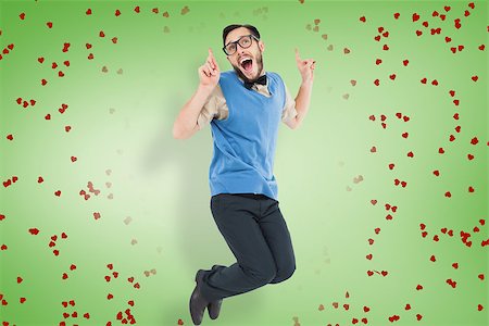 simsearch:400-08380794,k - Geeky hipster jumping and smiling against green vignette Stockbilder - Microstock & Abonnement, Bildnummer: 400-07935840