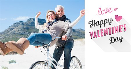 Carefree couple going on a bike ride on the beach  against cute valentines message Stock Photo - Budget Royalty-Free & Subscription, Code: 400-07935935