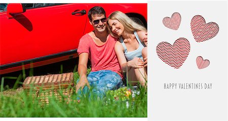 simsearch:400-07058112,k - Smiling couple sitting on the grass having picnic together against cute valentines message Photographie de stock - Aubaine LD & Abonnement, Code: 400-07935987