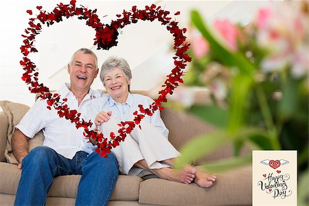 simsearch:400-04151970,k - Happy senior couple relaxing on sofa against happy valentines day Fotografie stock - Microstock e Abbonamento, Codice: 400-07936036
