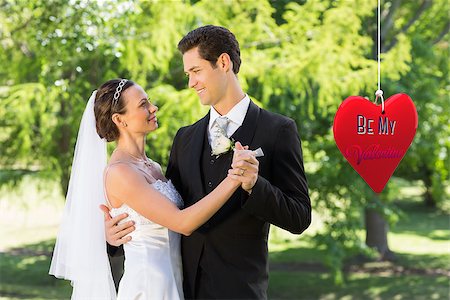 simsearch:400-07473236,k - Couple dancing on wedding day against be my valentine Stockbilder - Microstock & Abonnement, Bildnummer: 400-07936032