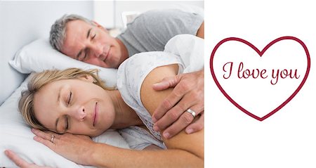 simsearch:400-06891126,k - Couple sleeping and spooning in bed against valentines love hearts Stock Photo - Budget Royalty-Free & Subscription, Code: 400-07936102