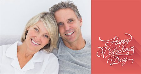 simsearch:400-06891126,k - Cheerful couple in bed against happy valentines day Stock Photo - Budget Royalty-Free & Subscription, Code: 400-07936161